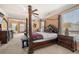 Comfortable main bedroom offers a four-poster bed, sitting area, and plenty of natural light at 3017 Canton Pines, Marietta, GA 30068