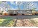 Home's backyard with a deck, lawn, and perimeter fence at 4275 Ridgetop Dr, Ellenwood, GA 30294