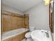 Bathroom with tub and shower tiled with decorative tilework at 4275 Ridgetop Dr, Ellenwood, GA 30294