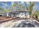 Single-story home featuring a well-kept yard and a long concrete driveway at 4275 Ridgetop Dr, Ellenwood, GA 30294