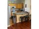 Galley kitchen with granite countertops, updated appliances, and breakfast bar seating at 1349 Orchard Park Dr, Stone Mountain, GA 30083