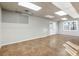 Spacious unfinished basement with tile floors and plenty of natural light, perfect for storage or recreation at 1701 Crowes Lake Ct, Lawrenceville, GA 30043
