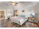 Comfortable bedroom with beautiful hardwood floors, decorative headboard, and an en suite bathroom at 1701 Crowes Lake Ct, Lawrenceville, GA 30043