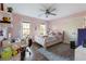 Pink bedroom with hardwood floors, a ceiling fan, and a cozy bed with plush pillows at 1701 Crowes Lake Ct, Lawrenceville, GA 30043