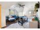 Bright bonus room featuring vaulted ceilings, a comfortable blue sofa, and a fun foosball table at 1701 Crowes Lake Ct, Lawrenceville, GA 30043