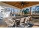 Relaxing covered deck with wood ceiling, furniture, and an outdoor dining area overlooking the backyard at 1701 Crowes Lake Ct, Lawrenceville, GA 30043