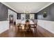 Formal dining room with dark walls, wainscoting, hardwood floors, and a large wooden dining table at 1701 Crowes Lake Ct, Lawrenceville, GA 30043