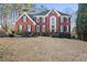 Beautiful brick home with black shutters, arched entryway, and well-manicured landscaping at 1701 Crowes Lake Ct, Lawrenceville, GA 30043