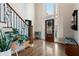 Bright foyer featuring hardwood floors, staircase with ornate iron railing, high ceilings and large windows at 1701 Crowes Lake Ct, Lawrenceville, GA 30043