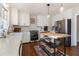 Modern kitchen featuring white cabinets, stainless steel appliances, marble countertops, and a butcher block island at 1701 Crowes Lake Ct, Lawrenceville, GA 30043