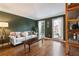 Comfortable living room with a stylish sofa, hardwood floors, and natural light from large windows at 1701 Crowes Lake Ct, Lawrenceville, GA 30043