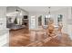 Open living space featuring hardwood floors, a stone fireplace, and a breakfast nook with bright natural lighting at 1701 Crowes Lake Ct, Lawrenceville, GA 30043