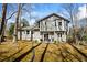 The rear exterior shows a patio with chairs, set among mature trees and landscaping at 6038 Maryjo Ln, Norcross, GA 30093