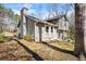 The rear exterior featuring neutral siding, white trim, and a concrete patio perfect for outdoor seating and entertaining at 6038 Maryjo Ln, Norcross, GA 30093