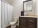 Bathroom featuring a dark wood vanity with marble countertop and shower with curtain at 6038 Maryjo Ln, Norcross, GA 30093