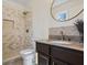 An updated bathroom featuring a granite-topped vanity, hexagon tile accents, and a modern shower with tile surround at 6038 Maryjo Ln, Norcross, GA 30093
