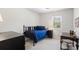 Neutral bedroom features a black metal bed frame, desk, and window at 6038 Maryjo Ln, Norcross, GA 30093