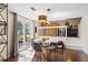 Cozy dining area with wood floors, modern lighting, and access to the backyard at 6038 Maryjo Ln, Norcross, GA 30093