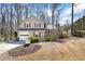 Charming two-story home with a well-maintained front yard and attached garage in a wooded neighborhood at 6038 Maryjo Ln, Norcross, GA 30093