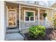 Inviting front porch with stone facade, white railings, and well-maintained landscaping at 6038 Maryjo Ln, Norcross, GA 30093