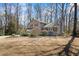 A two-story home with red shutters, a stone-accented porch, and lush landscaping at 6038 Maryjo Ln, Norcross, GA 30093