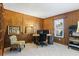 Home office with wood paneling, built-in shelving, and a large window at 6038 Maryjo Ln, Norcross, GA 30093