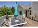 A cozy outdoor patio area with a dining table and chairs, perfect for gatherings and enjoying the backyard view at 6935 Autumn Hills Dr, Cumming, GA 30028