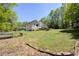 Expansive lawn in the backyard leads to a white deck, with ample space for outdoor activities at 6935 Autumn Hills Dr, Cumming, GA 30028