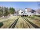 Home's backyard featuring a deck with patio furniture, a fire pit, and mature trees at 6935 Autumn Hills Dr, Cumming, GA 30028