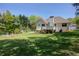 Scenic view of the home's backyard with an elevated deck and ample green space at 6935 Autumn Hills Dr, Cumming, GA 30028
