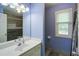 Bathroom with a single sink vanity, neutral countertops, and a tiled shower and floors at 6935 Autumn Hills Dr, Cumming, GA 30028