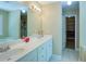 Bathroom with double sink vanity, modern fixtures, and walk-in closet access at 6935 Autumn Hills Dr, Cumming, GA 30028