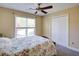 Bedroom featuring a plush bed, window views, and closet at 6935 Autumn Hills Dr, Cumming, GA 30028