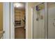 Bathroom with glass shower and walk in closet with built-in shelving at 6935 Autumn Hills Dr, Cumming, GA 30028