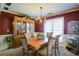A cozy dining room with an antique china cabinet and a large window, perfect for gatherings at 6935 Autumn Hills Dr, Cumming, GA 30028