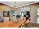 Traditional dining room features a chandelier, crown molding, and archway to living room at 6935 Autumn Hills Dr, Cumming, GA 30028
