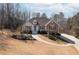 Charming single-story home featuring a manicured lawn, red shutters, and stone accents at 6935 Autumn Hills Dr, Cumming, GA 30028