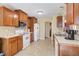 Functional kitchen with wood cabinets, white appliances and durable countertops at 6935 Autumn Hills Dr, Cumming, GA 30028