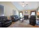 The living room has a fireplace, a ceiling fan and plenty of seating at 6935 Autumn Hills Dr, Cumming, GA 30028