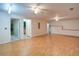 Spacious living room with hardwood floors and ceiling fans, with open access to adjacent rooms at 6935 Autumn Hills Dr, Cumming, GA 30028