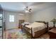 Comfortable bedroom with exterior door, ceiling fan, and a warm, inviting decor at 6935 Autumn Hills Dr, Cumming, GA 30028