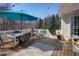 Outdoor patio set on a wooden deck with views of the surrounding backyard and trees at 6935 Autumn Hills Dr, Cumming, GA 30028