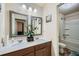 Bright bathroom featuring double sinks, decorative mirrors, and a shower-tub combo at 316 Silverwood Dr, Dallas, GA 30157