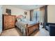 Cozy bedroom with a wood bed frame, complementary nightstand, and large window, creating a warm and inviting space at 316 Silverwood Dr, Dallas, GA 30157