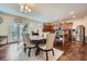 Bright dining area with seating for six, complemented by a view of the modern kitchen and stainless steel refrigerator at 316 Silverwood Dr, Dallas, GA 30157