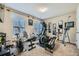 Well-equipped home gym with various workout machines, mirrors, and natural light, promoting a healthy and active lifestyle at 316 Silverwood Dr, Dallas, GA 30157