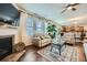 Comfortable living area featuring a fireplace, hardwood floors, bright windows, and open to the kitchen at 316 Silverwood Dr, Dallas, GA 30157