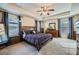 Serene main bedroom featuring neutral tones, carpet flooring, large windows, and decorative bedside tables at 316 Silverwood Dr, Dallas, GA 30157