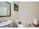 Cozy powder room featuring a pedestal sink and ornate mirror, offering a convenient and stylish space for guests at 316 Silverwood Dr, Dallas, GA 30157
