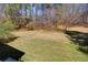 Spacious backyard showcasing lush greenery and mature trees, perfect for outdoor activities and relaxation at 3970 Brenteresa Ct, Snellville, GA 30039